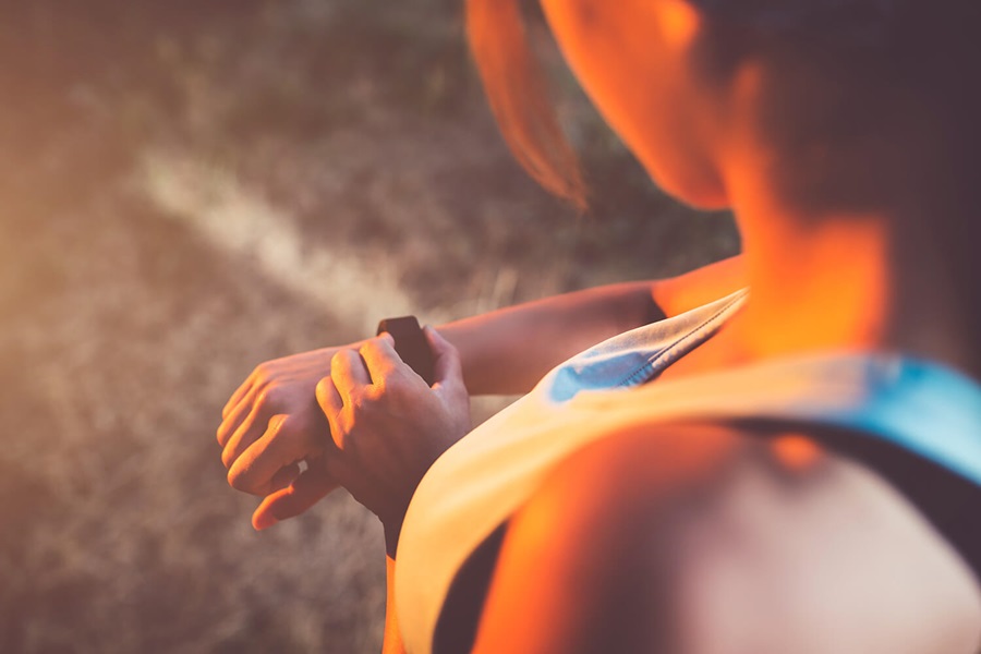 A person running calibrates their smart watch