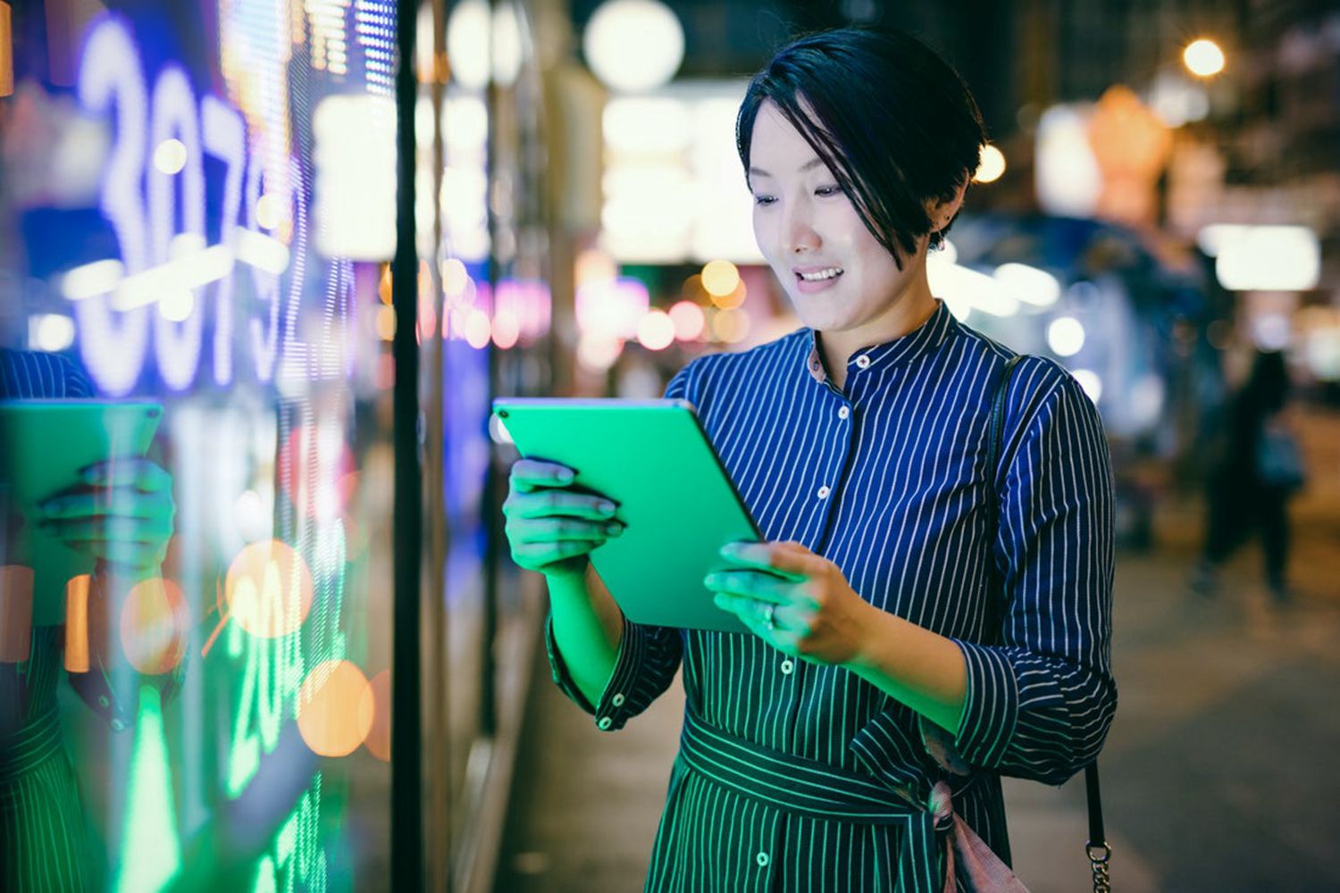 Asian businesswomen checking stock market data on tablet