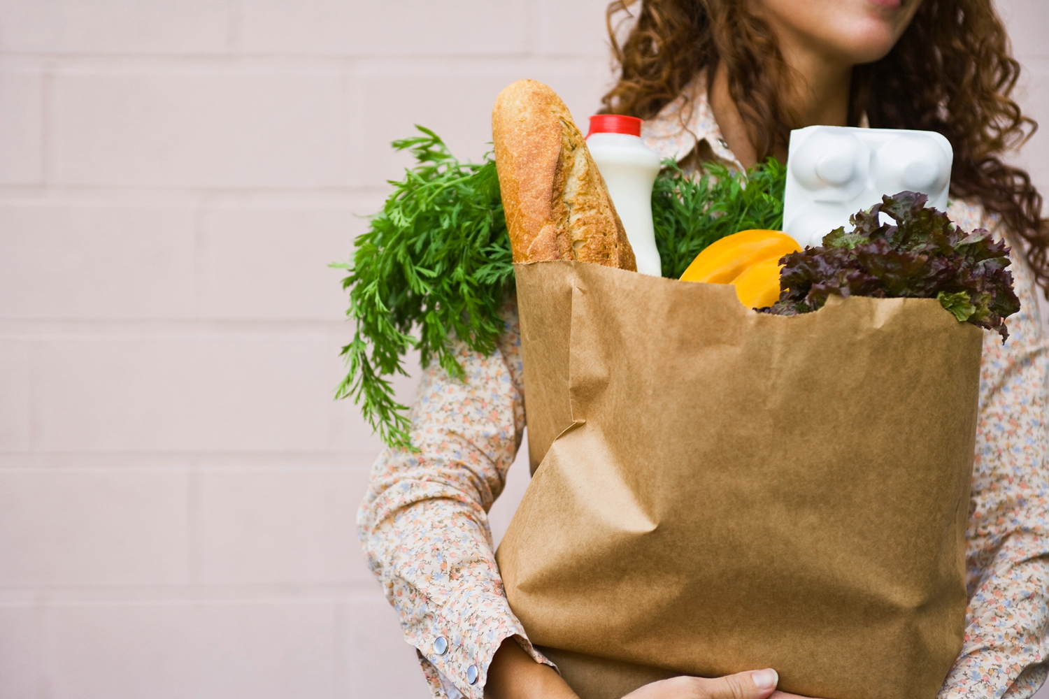 Woman carrying a bag of groceries