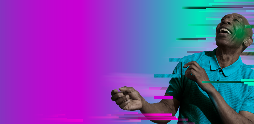 Image of a man smilling wearing a green polo